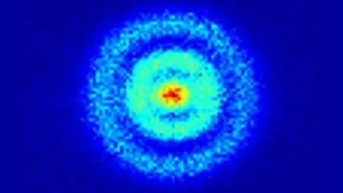 Real image of a hydrogen atom’s electron cloud, with the red nucleus at the center and blue rings showing electron probability