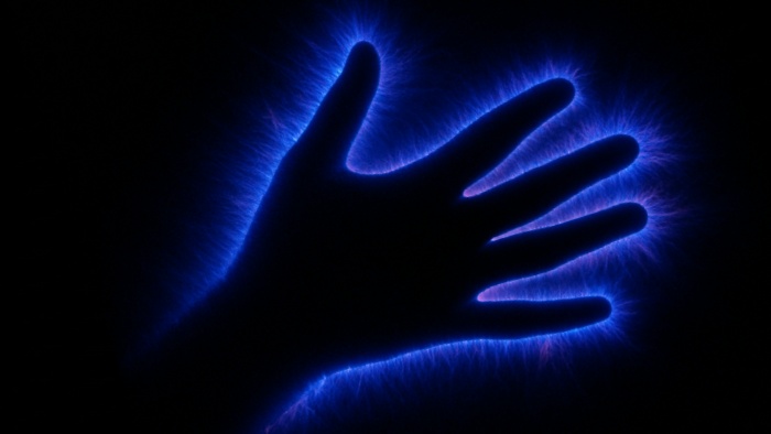 Kirlian photography showing an electric discharge around a leaf, interpreted by some as a human aura.